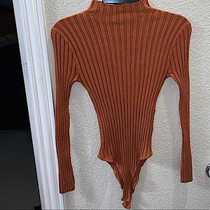 An orange-ish bodysuit size medium